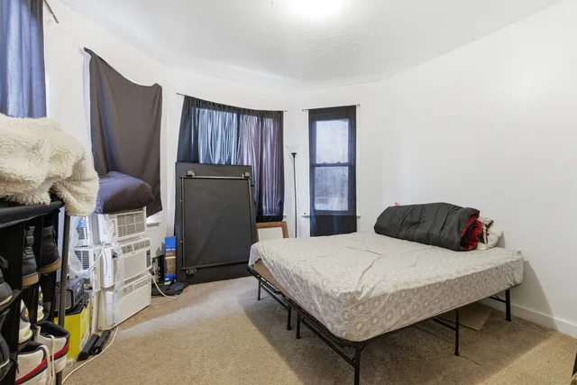 a bedroom with bed and a closet