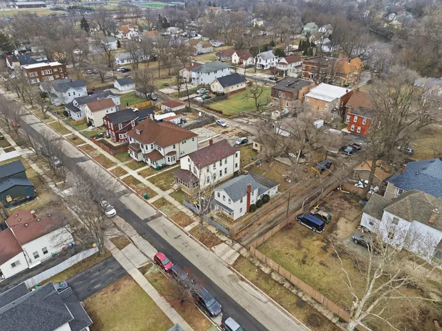 an aerial view of residential houses with yard
