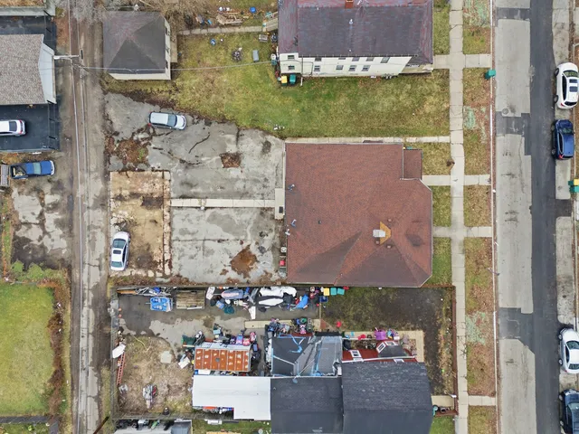 an aerial view of a house with a yard