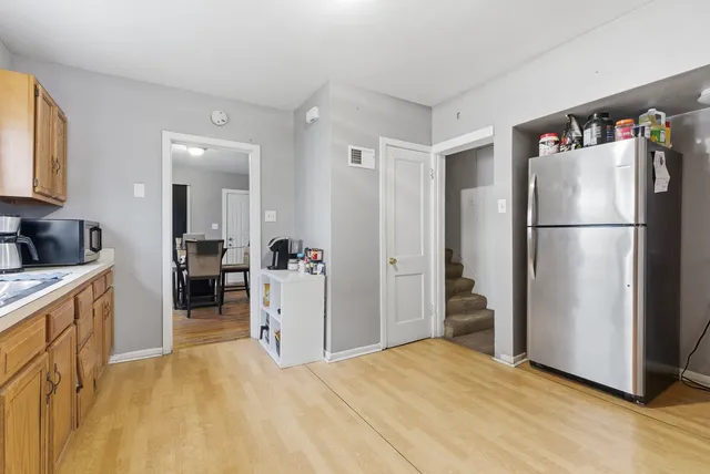 a kitchen with a refrigerator a stove top oven a washer and dryer
