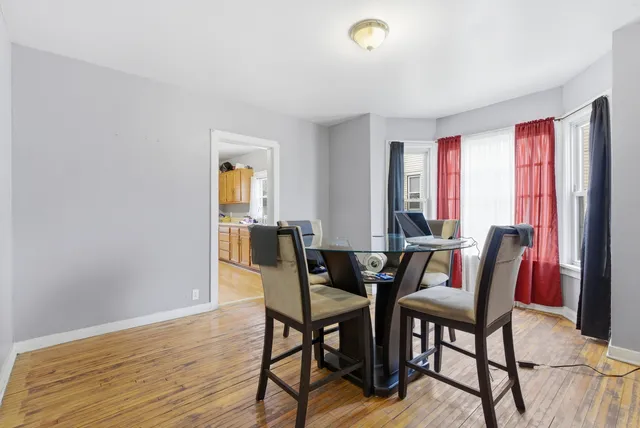a view of a dining room with furniture and window