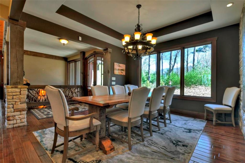 244 Wilderness Way Ellijay, GA 30536 - Photo 12 of 78 a view of a dining room with furniture wooden floor and chandelier