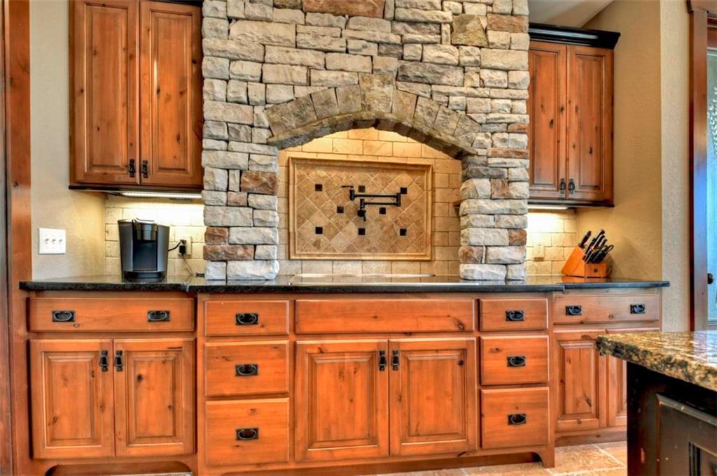244 Wilderness Way Ellijay, GA 30536 - Photo 14 of 78 a kitchen with granite countertop white cabinets and sink