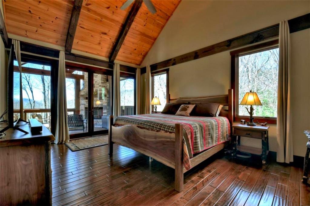 244 Wilderness Way Ellijay, GA 30536 - Photo 20 of 78 a bedroom with a bed and wooden floor