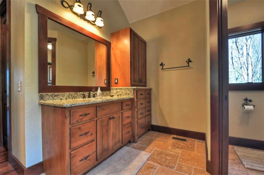 244 Wilderness Way Ellijay, GA 30536 - Photo 25 of 78 a bathroom with a double vanity sink and a mirror