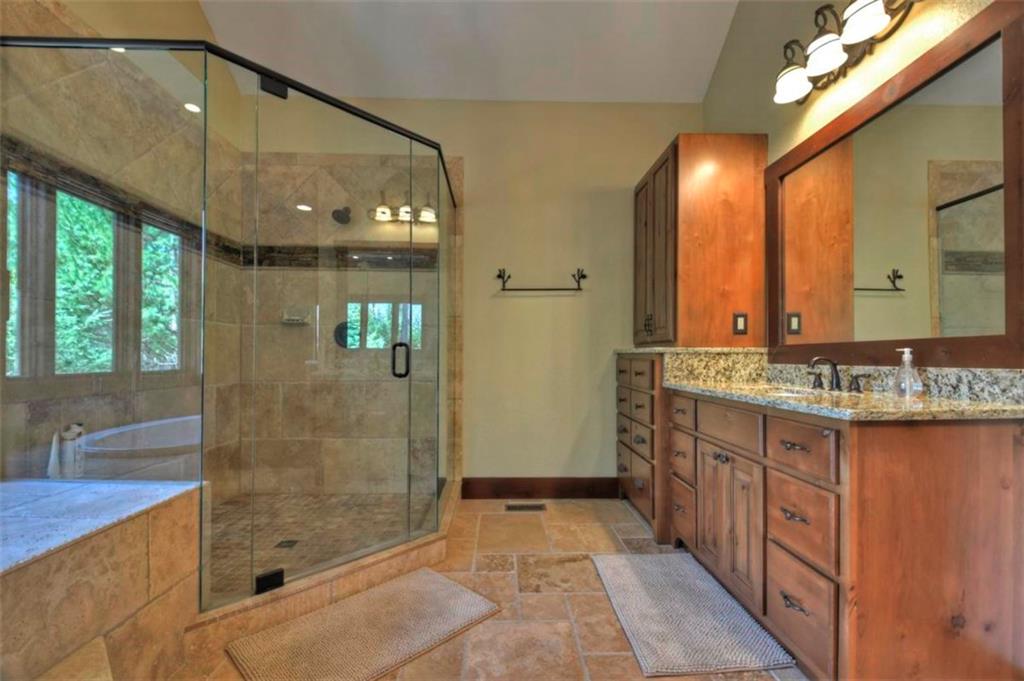 244 Wilderness Way Ellijay, GA 30536 - Photo 26 of 78 a bathroom with a sink a mirror and a shower