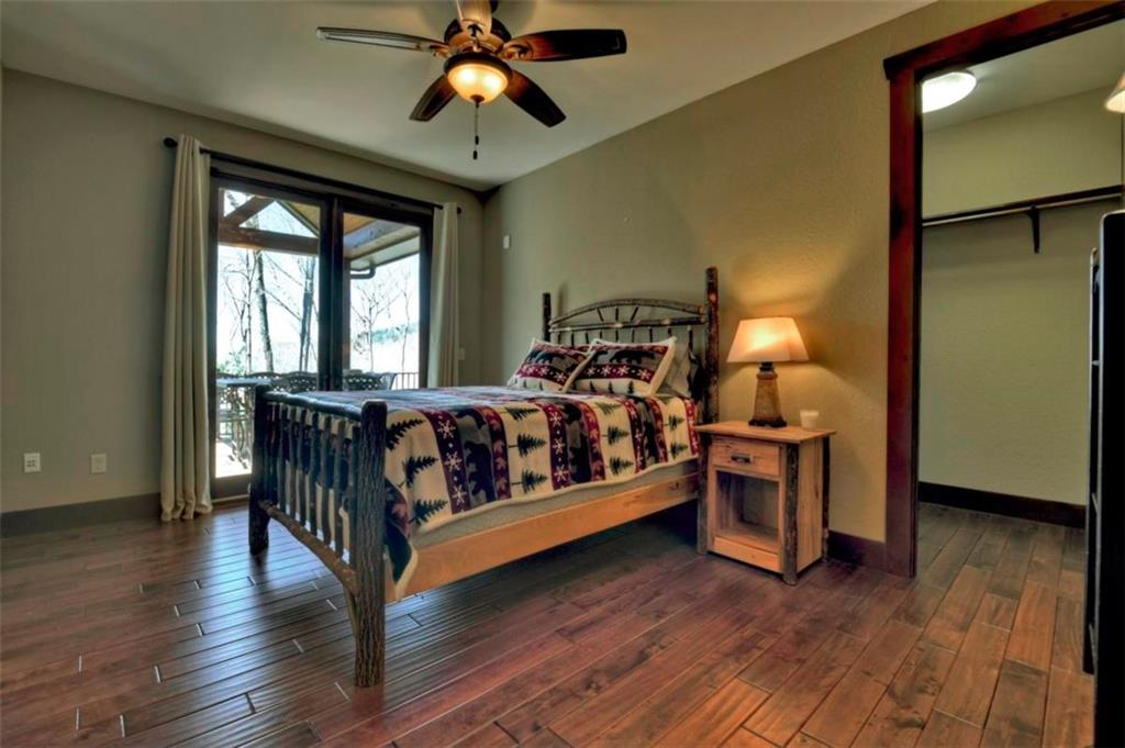244 Wilderness Way Ellijay, GA 30536 - Photo 28 of 78 a bedroom with furniture and wooden floor