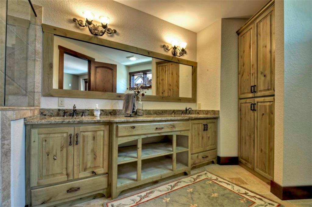 244 Wilderness Way Ellijay, GA 30536 - Photo 29 of 78 a bathroom with a granite countertop sink and a mirror