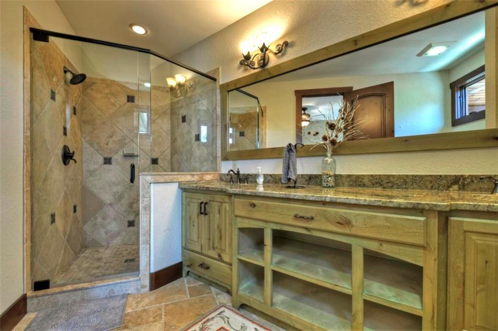 244 Wilderness Way Ellijay, GA 30536 - Photo 30 of 78 a bathroom with a granite countertop sink mirror and shower
