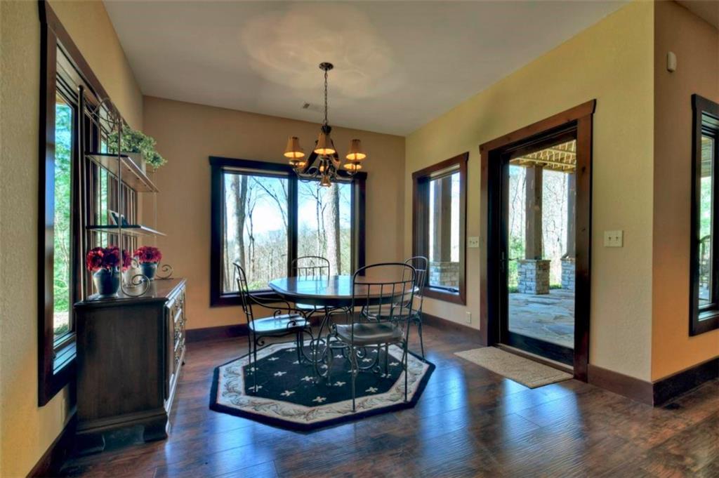 244 Wilderness Way Ellijay, GA 30536 - Photo 35 of 78 a living room with furniture and a chandelier