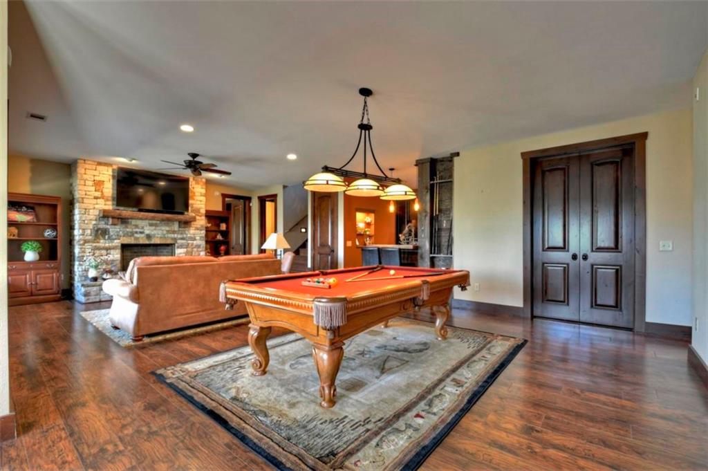 244 Wilderness Way Ellijay, GA 30536 - Photo 37 of 78 a living room with furniture a dining table and a fireplace