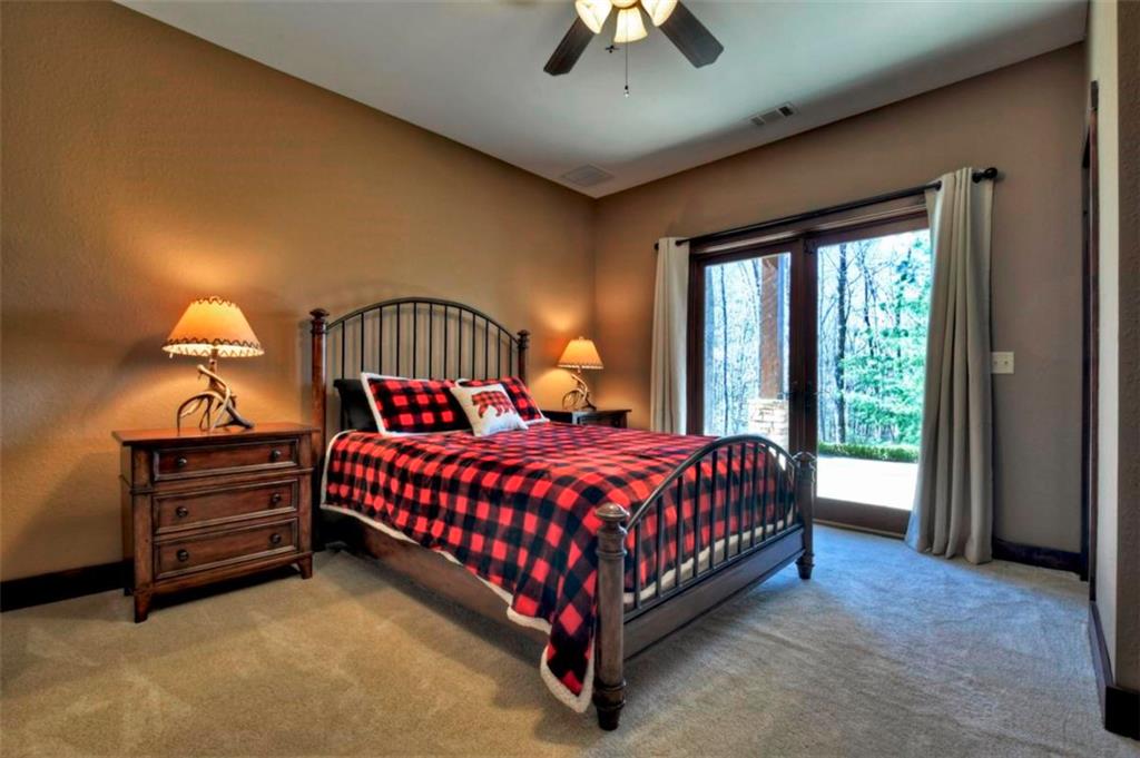 244 Wilderness Way Ellijay, GA 30536 - Photo 42 of 78 a bed sitting in a spacious bedroom next to a window