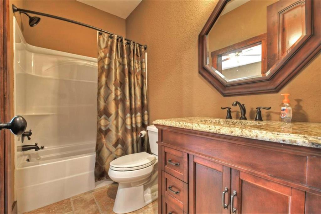 244 Wilderness Way Ellijay, GA 30536 - Photo 43 of 78 a bathroom with a granite countertop sink toilet and shower