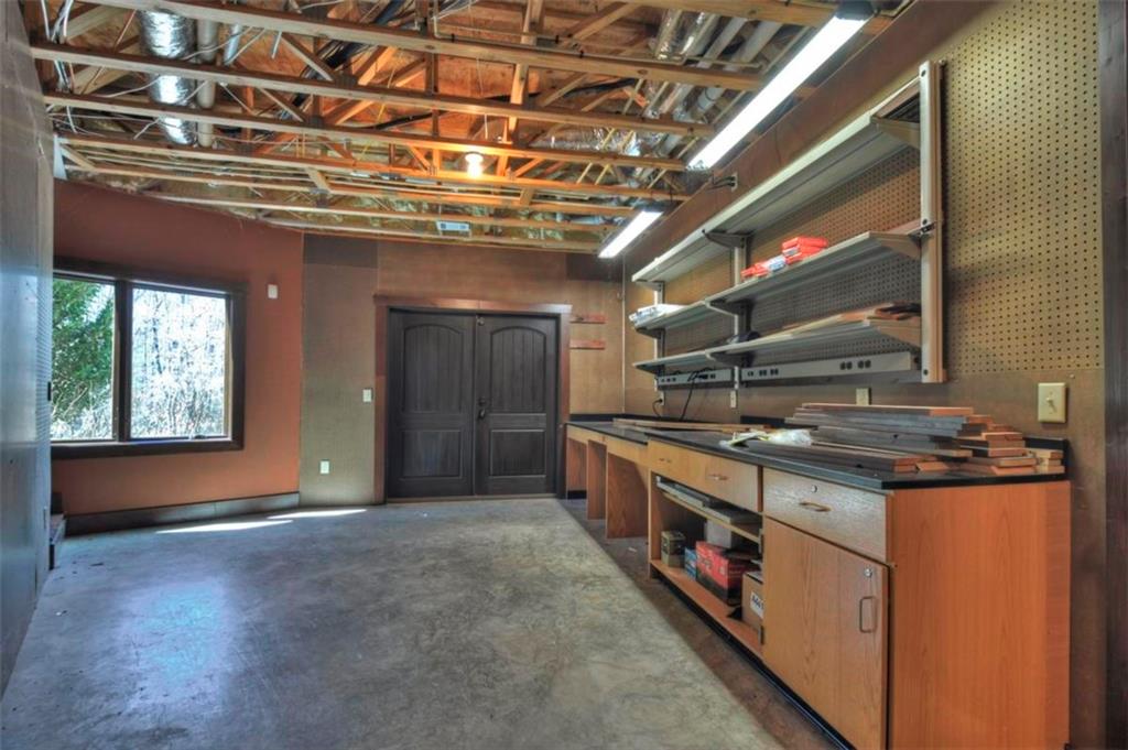 244 Wilderness Way Ellijay, GA 30536 - Photo 44 of 78 a kitchen with stainless steel appliances granite countertop a stove a sink and a microwave