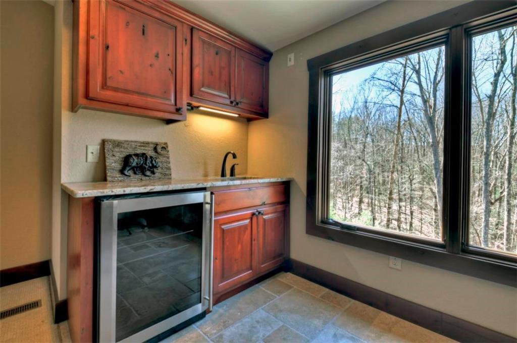244 Wilderness Way Ellijay, GA 30536 - Photo 49 of 78 a kitchen with stainless steel appliances granite countertop a stove sink and cabinets