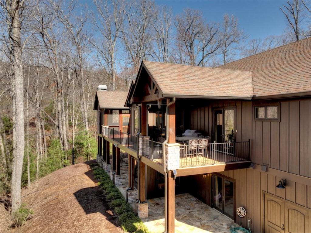 244 Wilderness Way Ellijay, GA 30536 - Photo 52 of 78 a view of a patio with table and chairs with wooden floor and fence