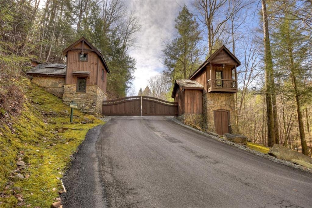 244 Wilderness Way Ellijay, GA 30536 - Photo 75 of 78 a front view of a house with a yard and garage