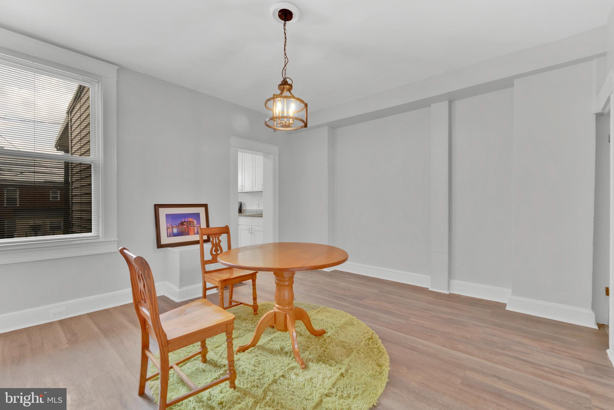747 East 37th Street Baltimore, MD 21218 - Photo 14 of 53 a view of a dining room with furniture wooden floor and a chandelier