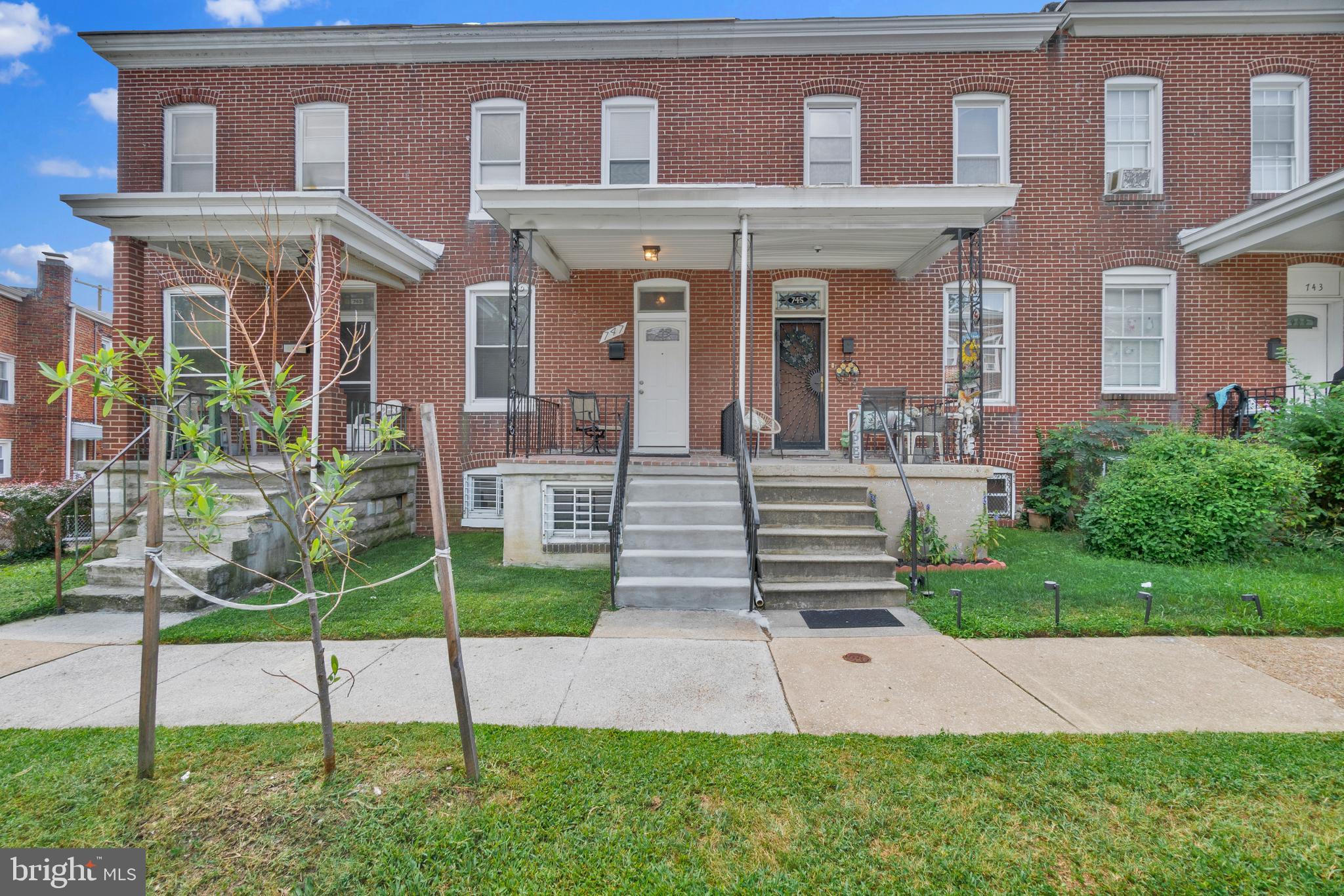 747 East 37th Street Baltimore, MD 21218 - Photo 2 of 53 a front view of a house with a yard
