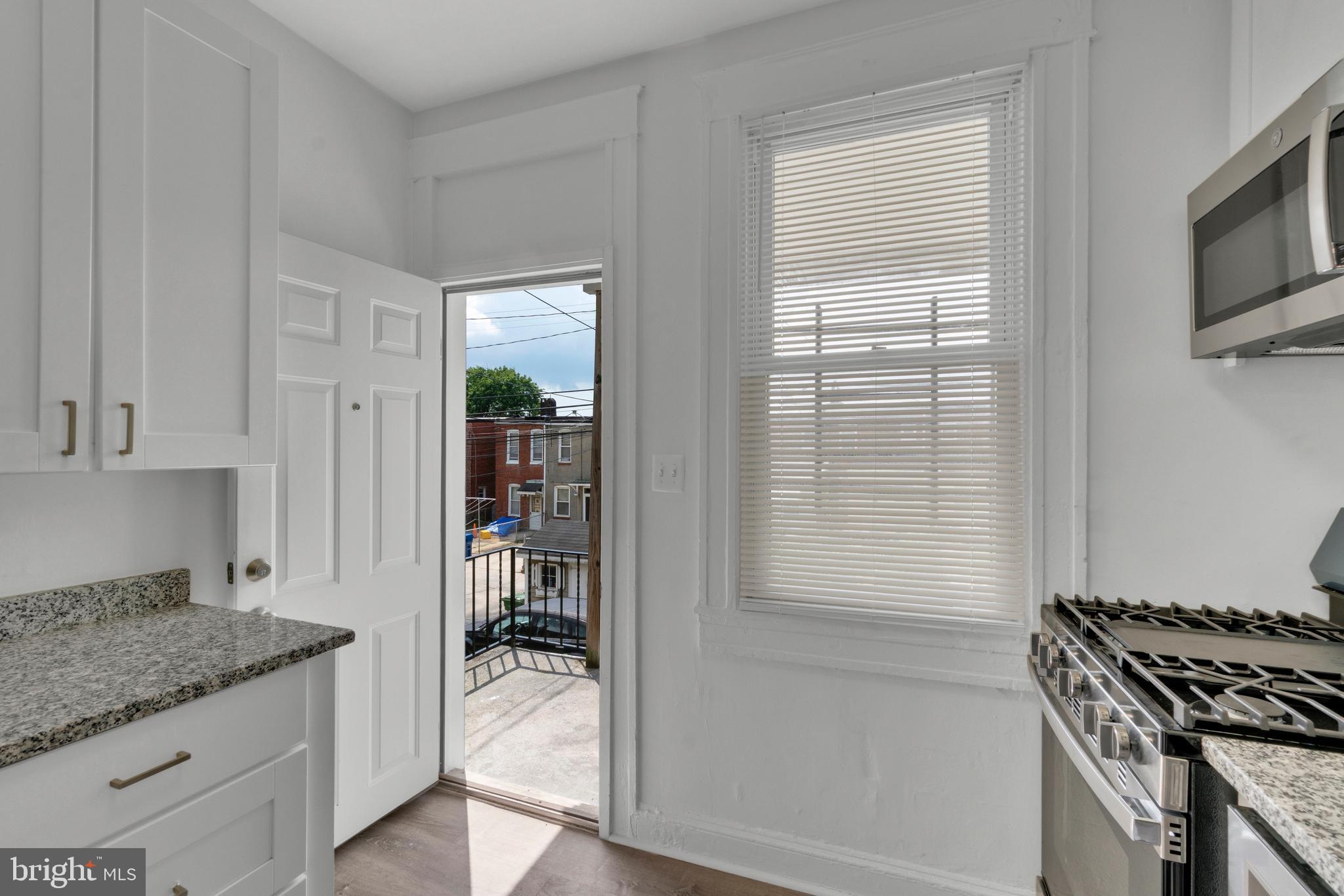 747 East 37th Street Baltimore, MD 21218 - Photo 21 of 53 a kitchen with a stove and a refrigerator