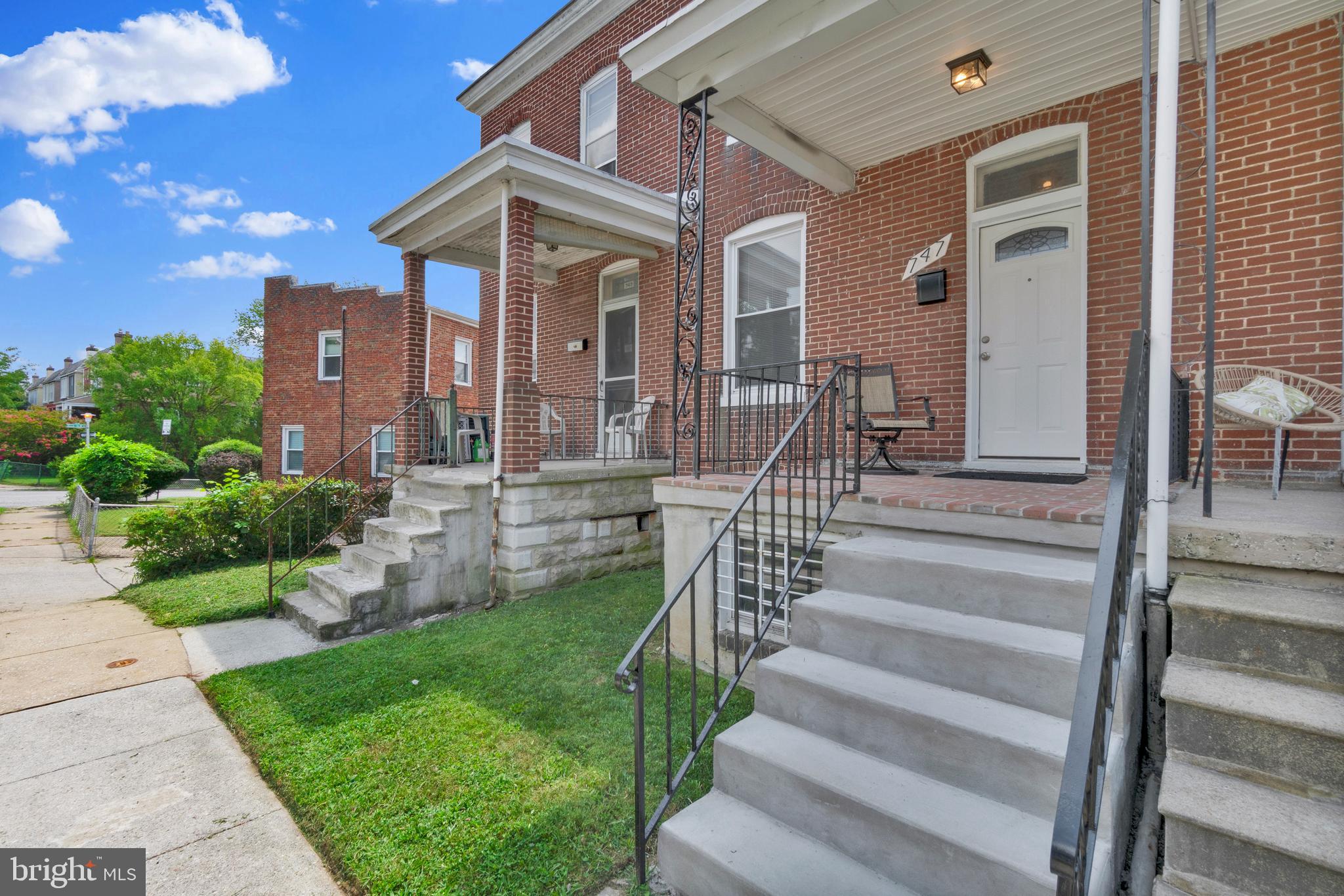 747 East 37th Street Baltimore, MD 21218 - Photo 3 of 53 a front view of a house with a yard