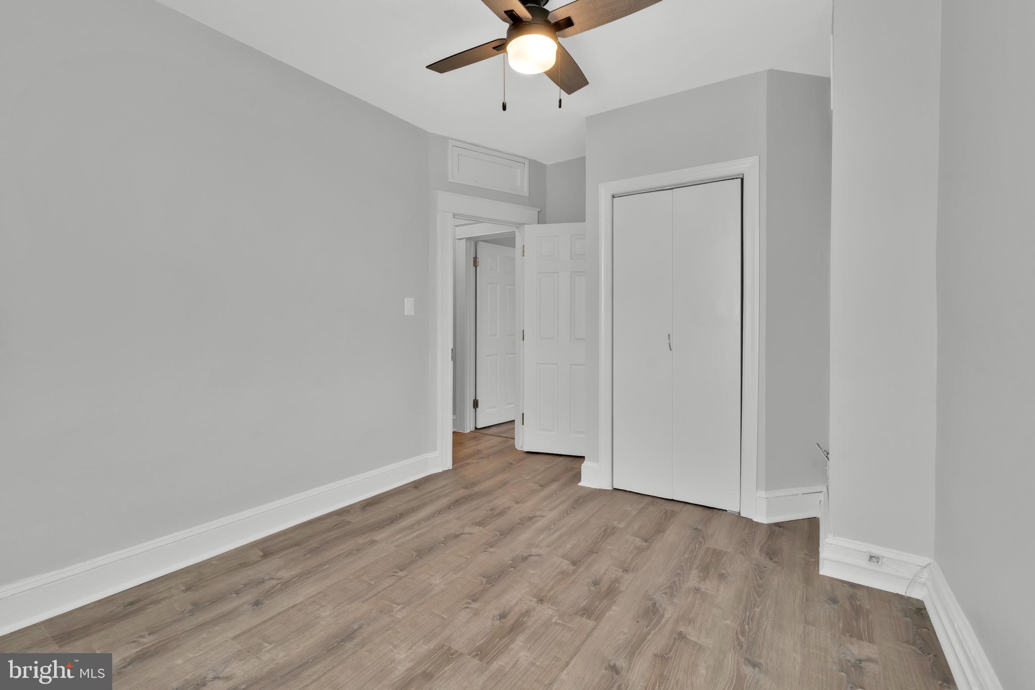 747 East 37th Street Baltimore, MD 21218 - Photo 34 of 53 wooden floor in an empty room with a chandelier fan