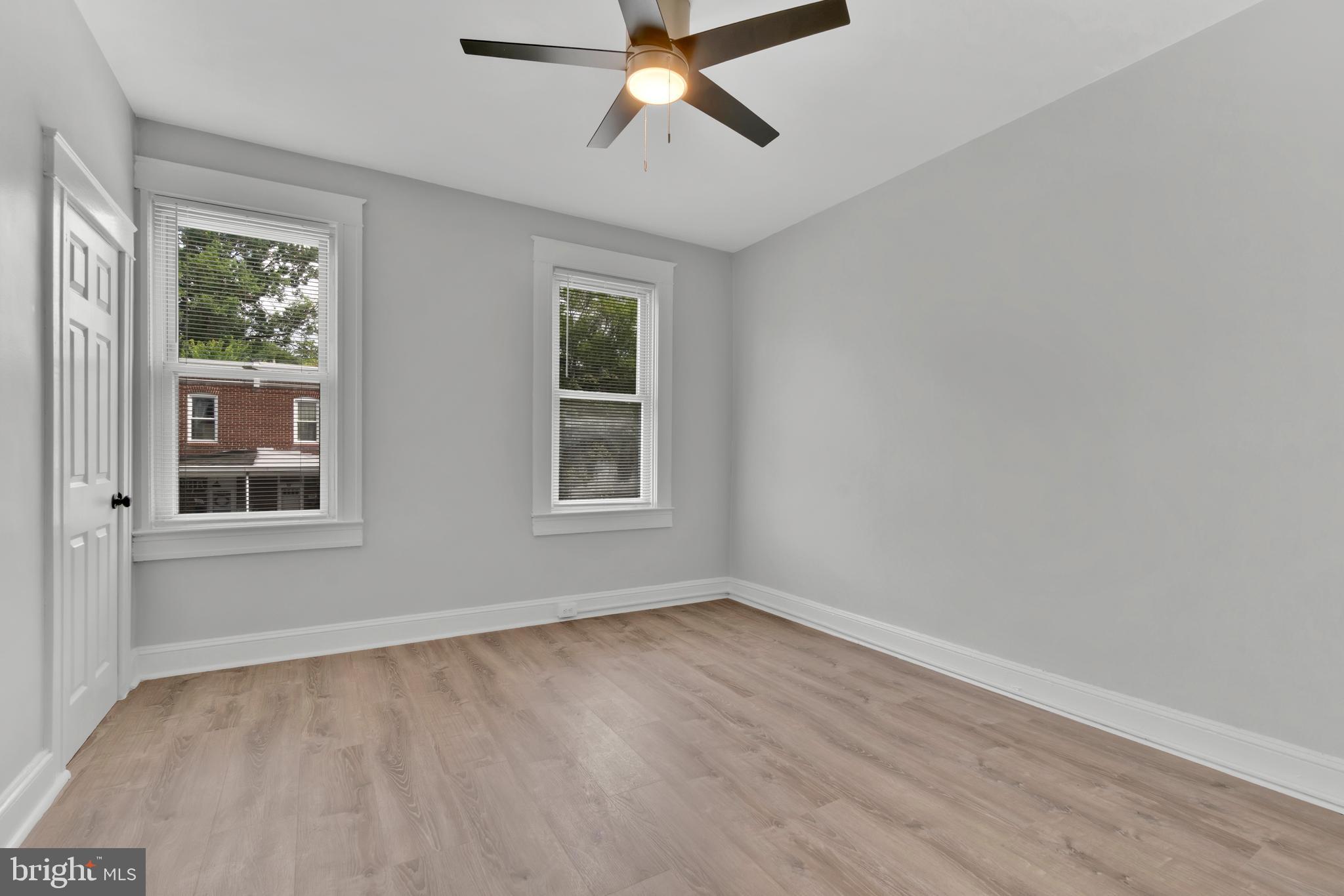 747 East 37th Street Baltimore, MD 21218 - Photo 35 of 53 a view of empty room with wooden floor and fan