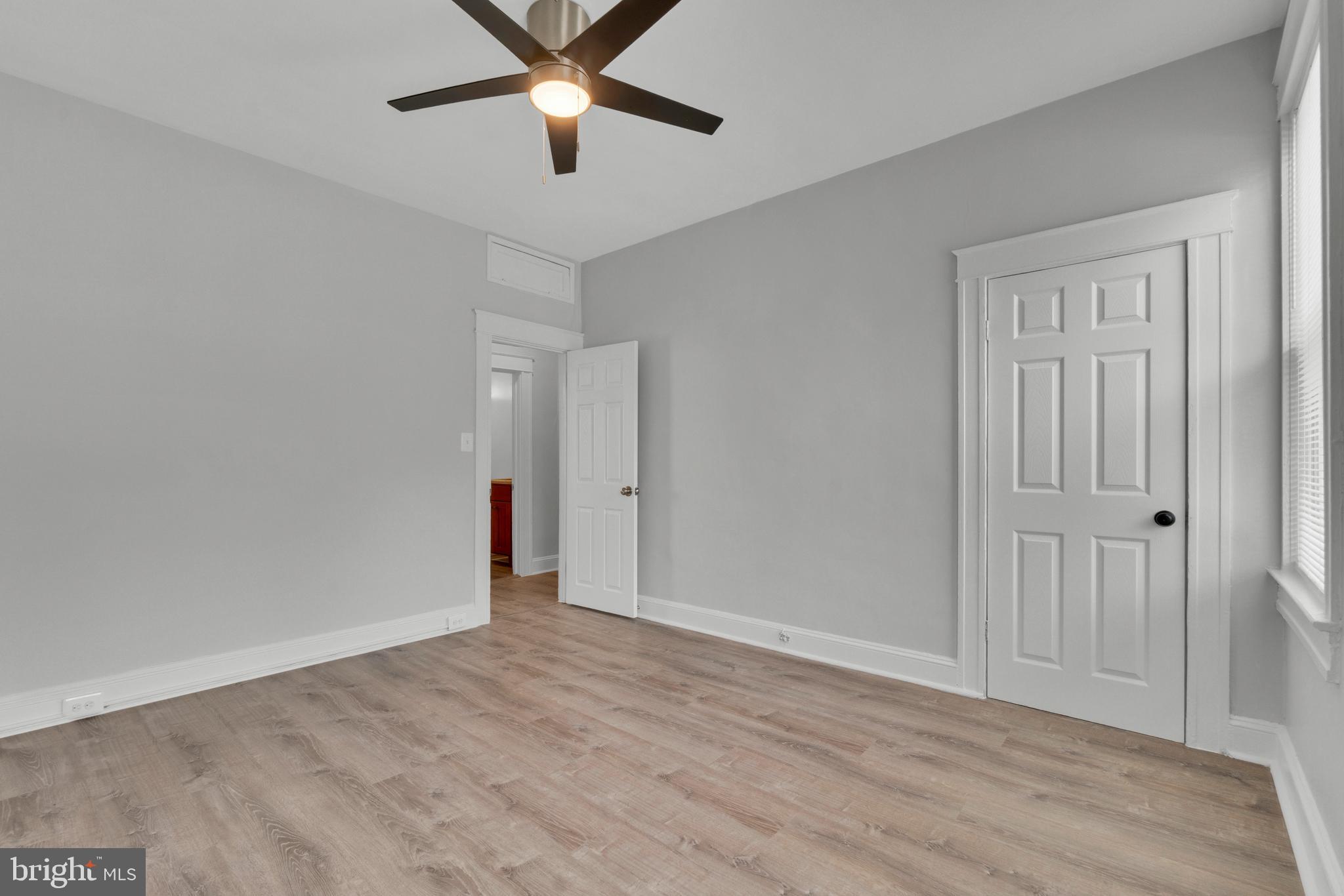 747 East 37th Street Baltimore, MD 21218 - Photo 38 of 53 an empty room with wooden floor and windows