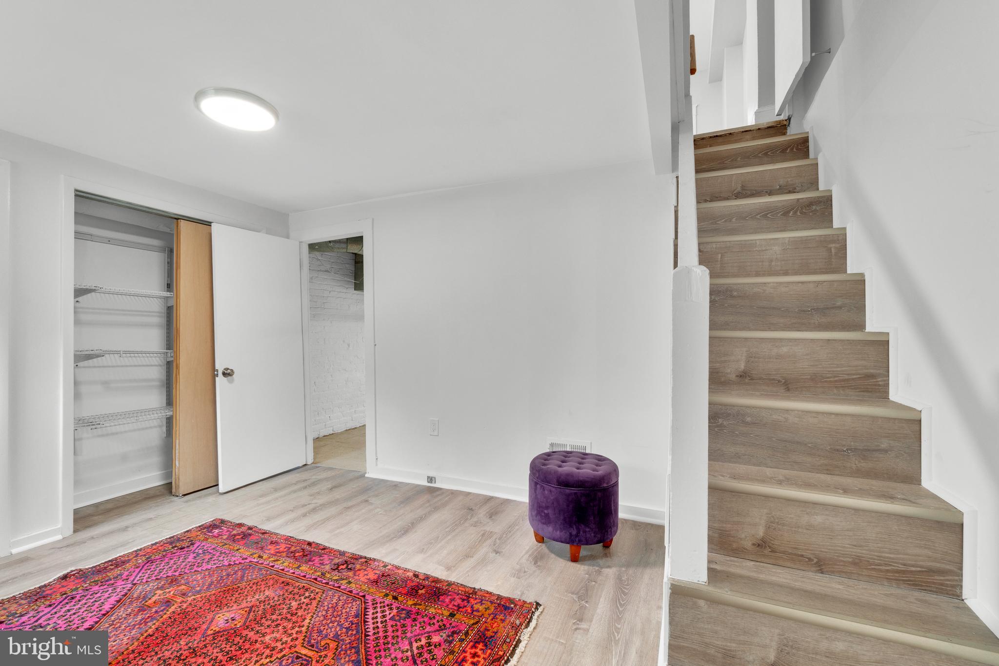 747 East 37th Street Baltimore, MD 21218 - Photo 40 of 53 a view of room with stairs and wooden floor