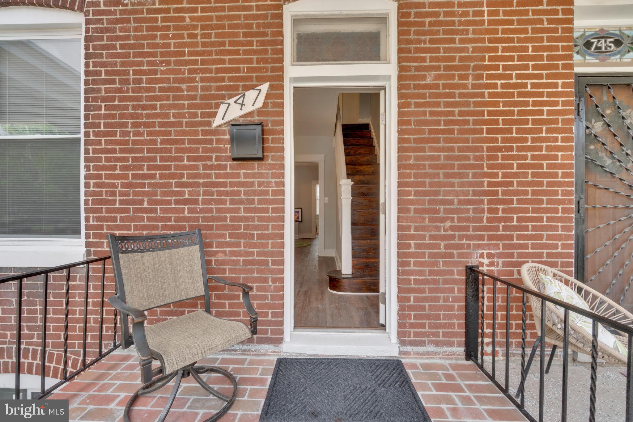 747 East 37th Street Baltimore, MD 21218 - Photo 5 of 53 a brick building with a bench and a window