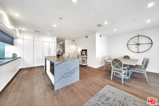 a living room with furniture and kitchen view