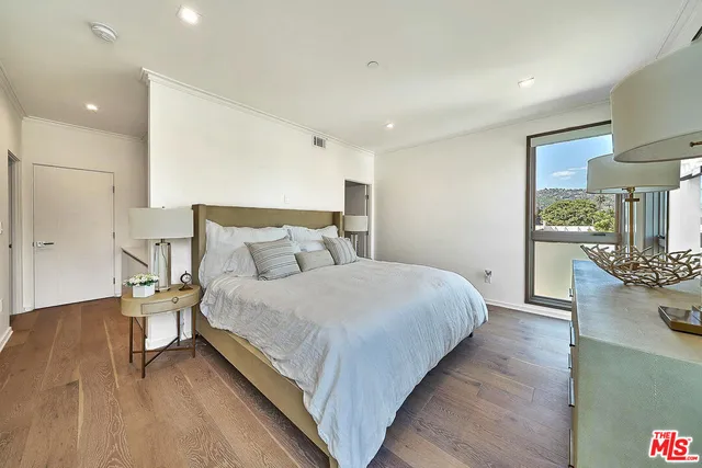 a bedroom with bed and window