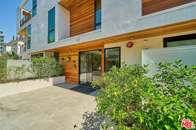 a view of a building with potted plants