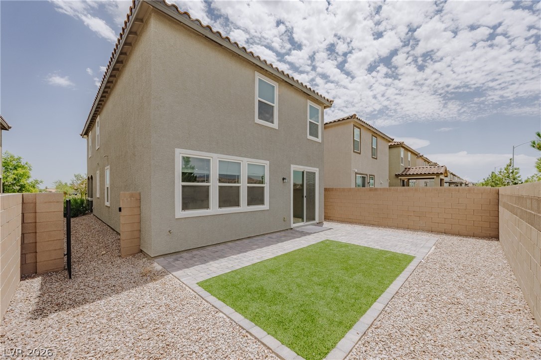 5927 Coja Street Las Vegas, NV 89113 - Photo 5 of 32 Rear view of property with stucco siding, a tiled roof, and a patio