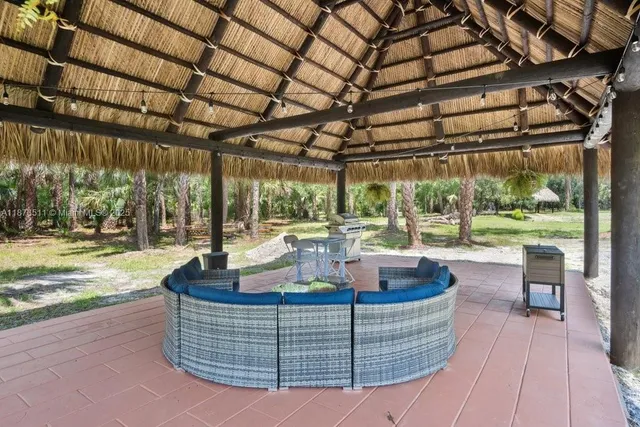 a living room with furniture potted plant and windows