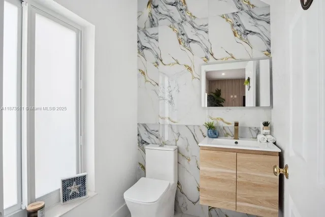 a kitchen with granite countertop a sink stove and refrigerator