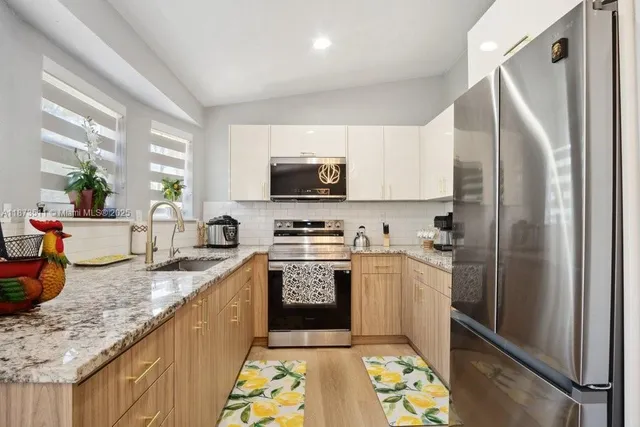 a white bath tub sitting in a bathroom next to a window