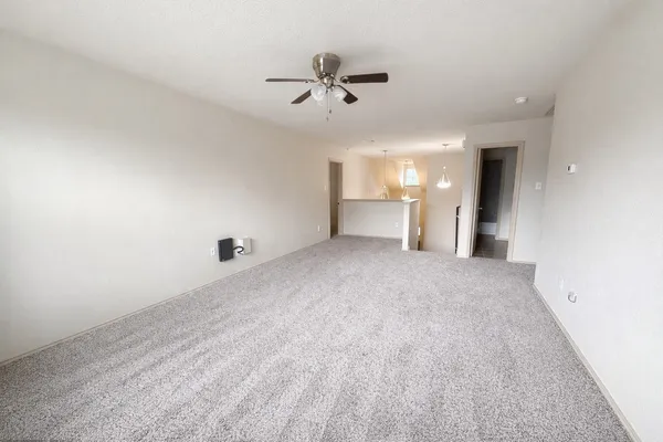 a view of a livingroom with a ceiling fan and window