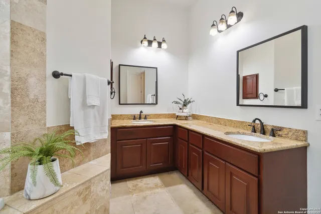 a bathroom with a double vanity sink and a bathtub