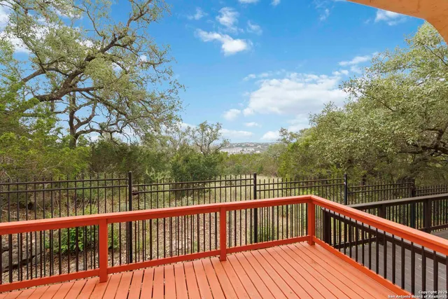 a view of balcony with wooden floor and fence