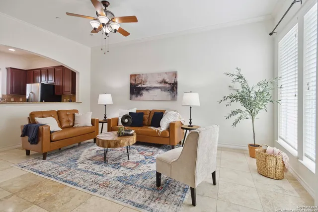 a living room with furniture potted plant and a window