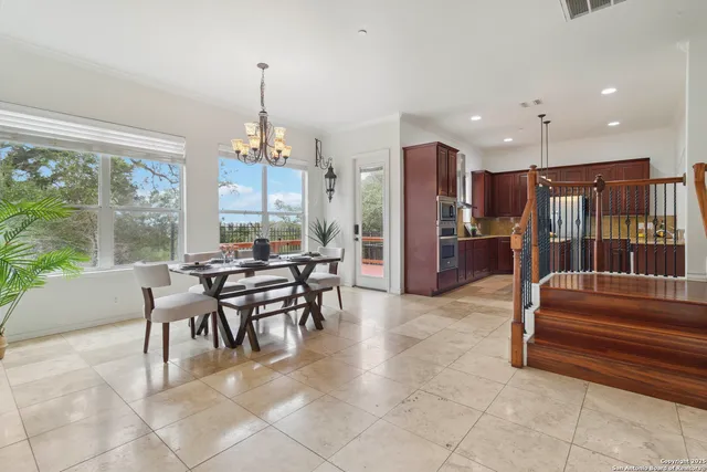 a dining room with furniture a chandelier and fireplace
