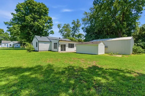 a view of a house with a backyard