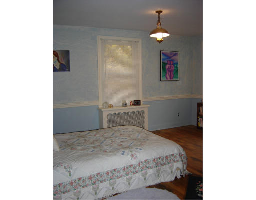 40 Maple Street Sturbridge, MA 01566 - Photo 5 of 5 a bedroom with a bed and a chandelier