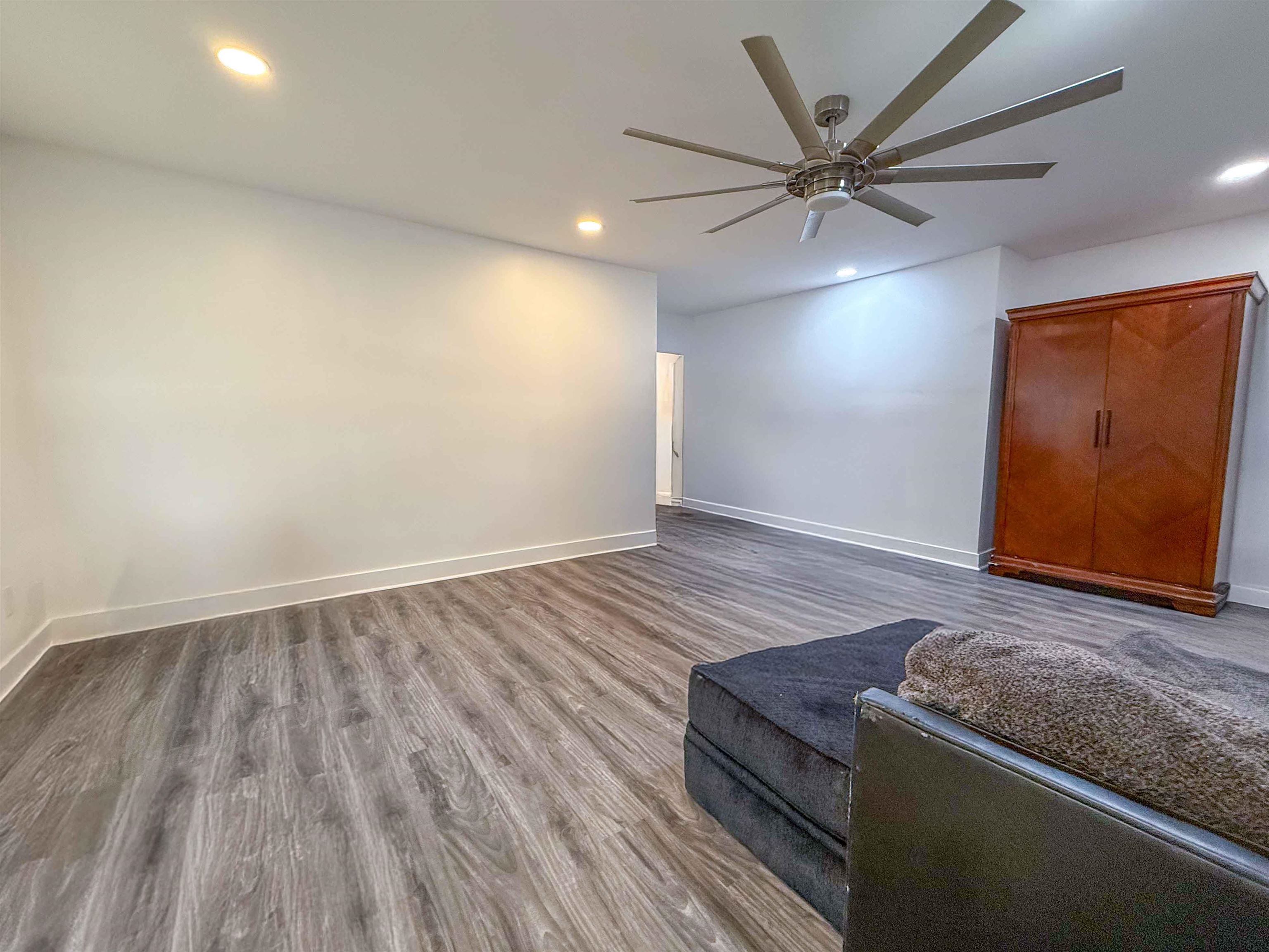 2582 James Road Memphis, TN 38127 - Photo 5 of 36 an empty room with wooden floor fan and windows