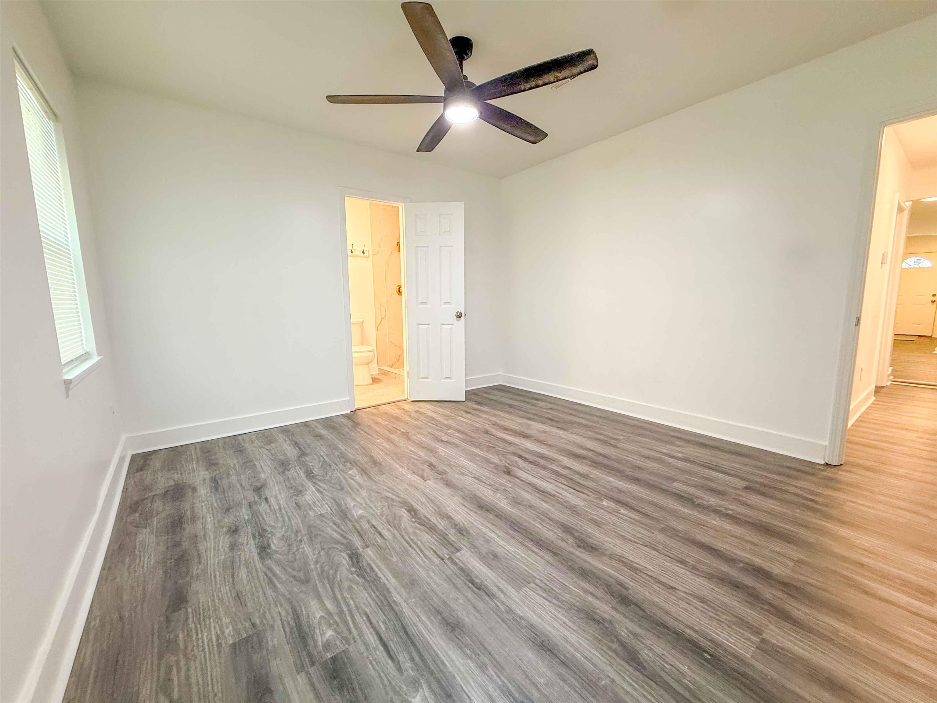 2582 James Road Memphis, TN 38127 - Photo 9 of 36 an empty room with wooden floor and a ceiling fan