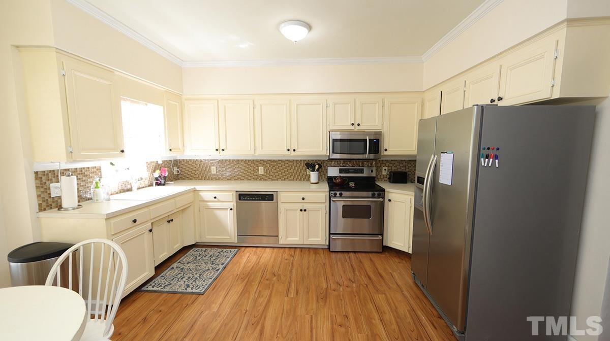 7614 Wilderness Road Raleigh, NC 27613 - Photo 3 of 21 Enjoy the bright natural light while sitting in the breakfast nook.