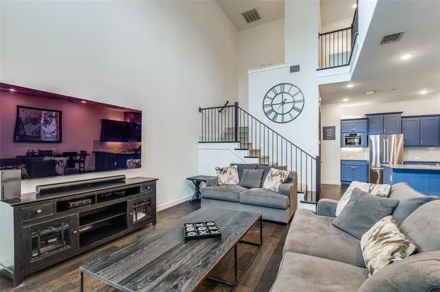 a living room with furniture and a baby crib