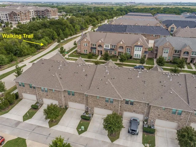 an aerial view of residential houses with outdoor space