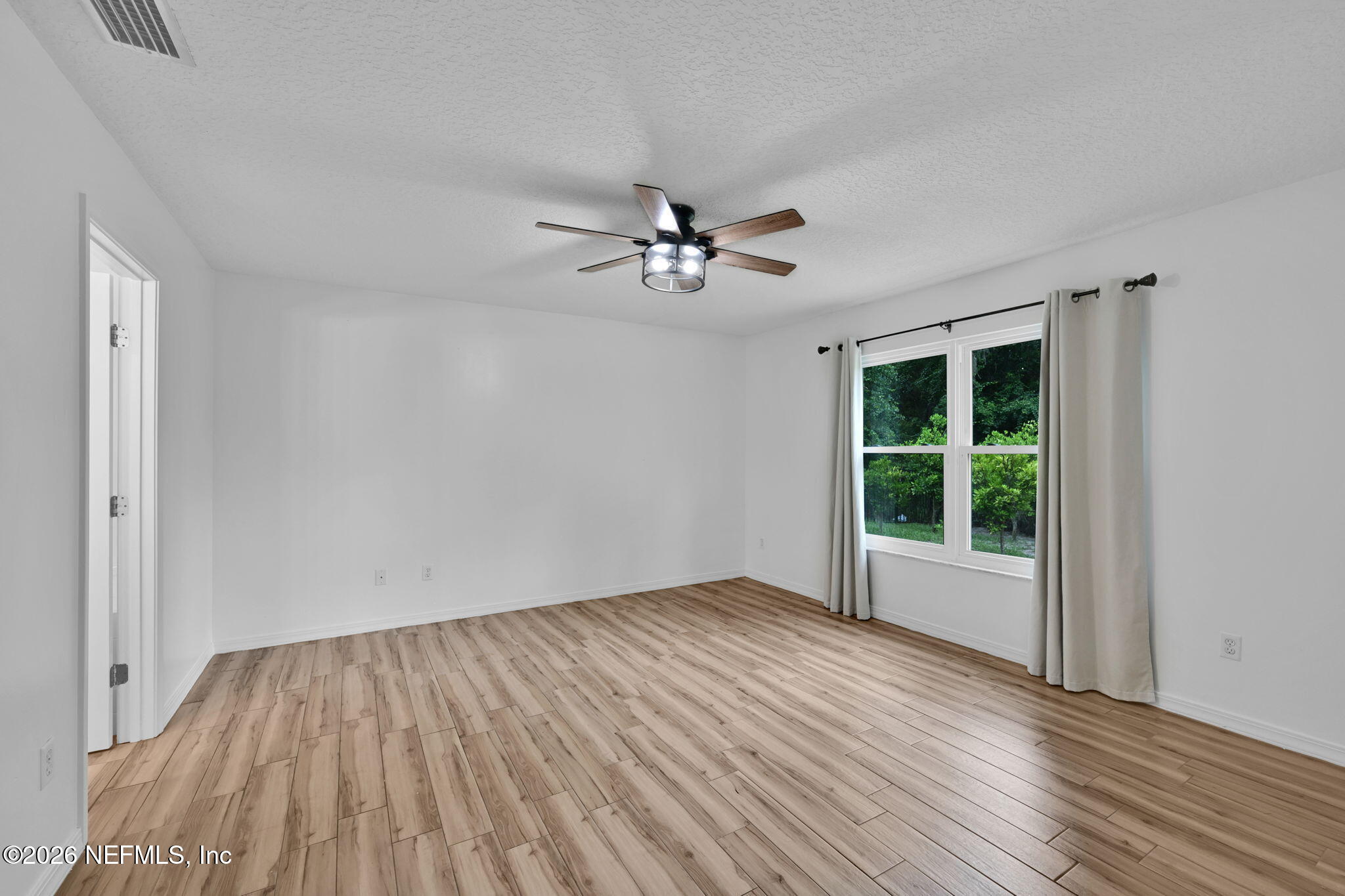1110 Woodlawn Road, Unit D St. Augustine, FL 32084 - Photo 27 of 40 a view of empty room with wooden floor and fan